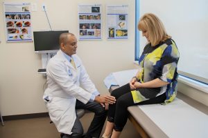 Dr. Gobezie helps a patient with knee pain