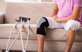 Photo of a person sitting on a couch with a knee brace on