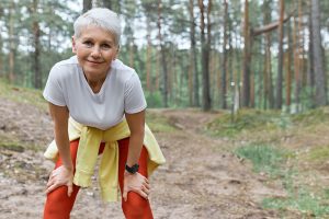 Older woman wearing workout attire in the outdoors